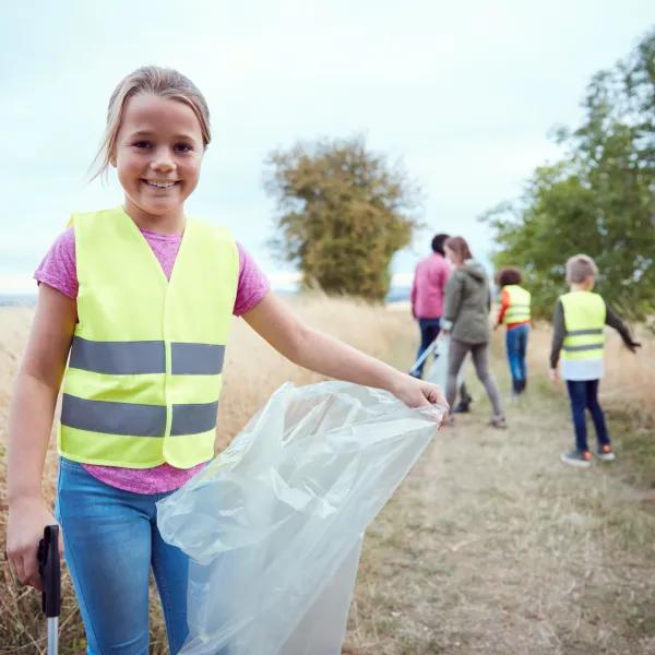 Child holding bag for litter picking