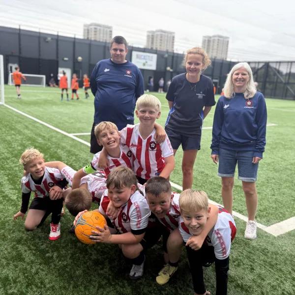 Sarah, Jen and the team with a football