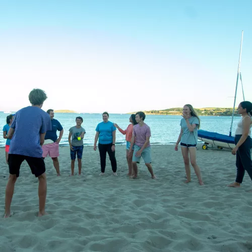 young people playing on beach