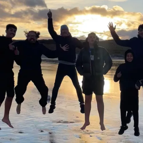 Group pf young people jumping on the beach