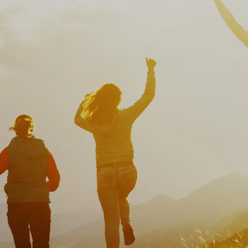 Teenagers jumping at sunset